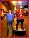 tall man imitates canadian mountie statue