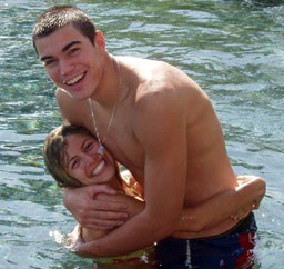 Tall swimmer hugs girlfriend