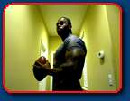 black bodybuilder throwing football